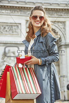 woman with shopping bags in Paris, France looking into distance