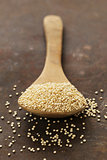 Natural organic cereal quinoa in a wooden spoon