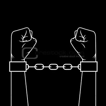 Hands with clenched fists in shackles - slavery concept