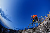 Mountain biker in action across rocks