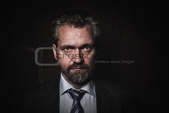 Portrait of a mature businessman on black background