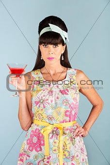 Serious woman in dress holding alcoholic beverage