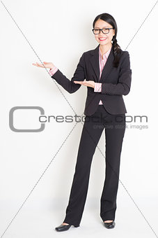 Asian businesswoman showing something