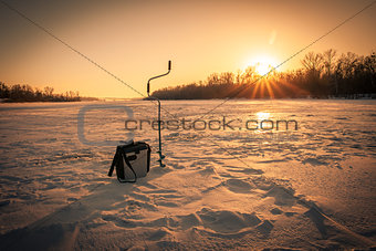 Ice fishing on sunrise