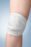 Injured female knee with bandage