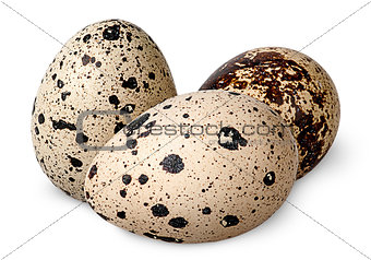 Three quail eggs beside