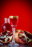 sweet pomegranate alcoholic cordial in the decanter with a glass