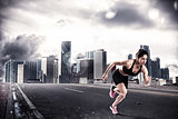 Athletic woman runner on the asphalt of a city road