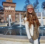 happy young tourist woman in Milan, Italy looking into distance