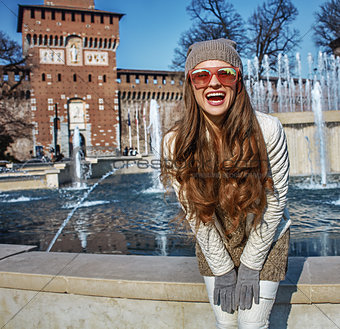 happy modern woman near Sforza Castle in Milan, Italy