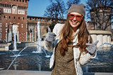 woman near Sforza Castle in Milan, Italy showing thumbs up