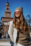 smiling woman near Sforza Castle in Milan, Italy looking aside