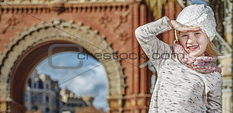 girl near Arc de Triomf in Barcelona looking into distance