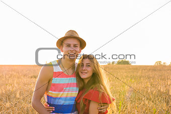 portrait of romantic couple embraces in the field
