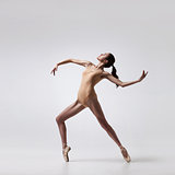 young beautiful ballet dancer in beige swimsuit