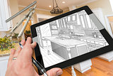Hand on Computer Tablet Showing Drawing of Kitchen Photo Behind 