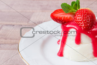 panna cotta dessert with strawberry sirup and mint leaf
