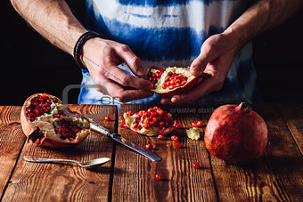 Opened Pomegranate Fruit in Hands