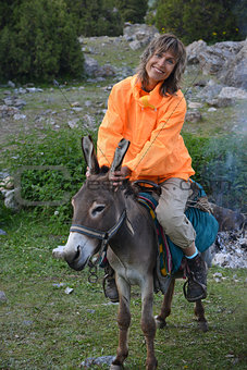 Smiling woman on donkey