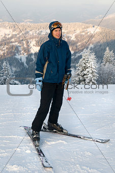 Woman - skier in snowy mountains