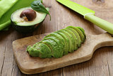 healthy eating - ripe avocado on a wooden board