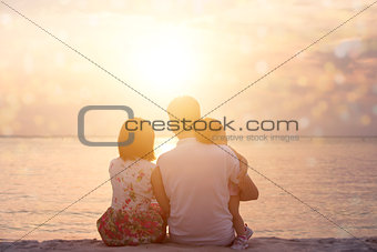 Family enjoying sunset view at seaside