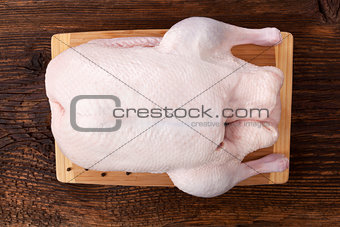 Fresh raw duck on wooden table.