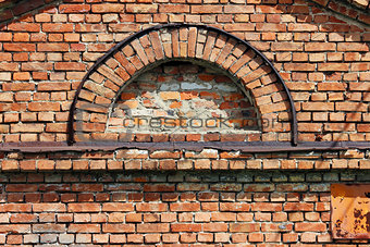 texture semi-circular window in the old historic brick building.