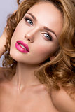 Glamour portrait of beautiful woman model with fresh makeup and romantic wavy hairstyle.