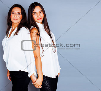 cute pretty teen daughter with mature mother hugging, fashion st