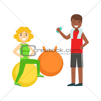 Woman Doing Exercise On Ball WIth Help Of Personal Trainer, Member Of The Fitness Club Working Out And Exercising In Trendy Sportswear
