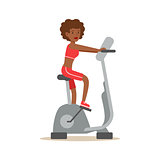 Woman On Bicycle Simulator Equipment , Member Of The Fitness Club Working Out And Exercising In Trendy Sportswear