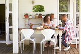 Couple At Home Eating Outdoor Meal Together