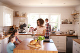 Family At Home Eating Breakfast In Kitchen Together