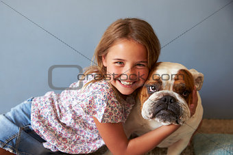 Portrait Of Smiling Girl With Pet British Bulldog