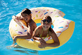 Children Having Fun With Inflatable In Outdoor Swimming Pool