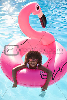 Girl Having Fun With Inflatable In Outdoor Swimming Pool