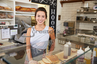 Female business owner behind the counter at a sandwich bar