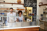 Mixed race couple behind the counter at a sandwich bar