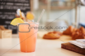 Glass of lemonade on the counter at a coffee shop, horizontal