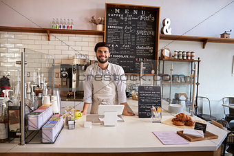 Business owner standing behind the counter at a coffee shop