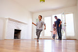 Excited Family Explore New Home On Moving Day