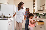 Family At Home Preparing Meal In Kitchen Together