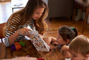 Mother Playing With Children On Table At Home