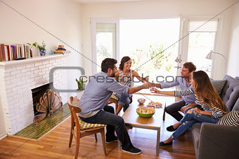 Couple Entertaining Friends At Home
