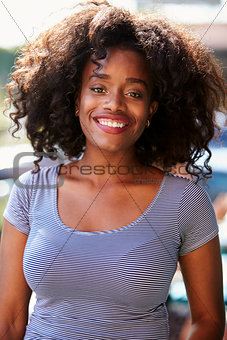 Outdoor Portrait Of Attractive Young Woman Smiling At Camera