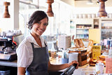Portrait Of Female Employee Working At Delicatessen Checkout