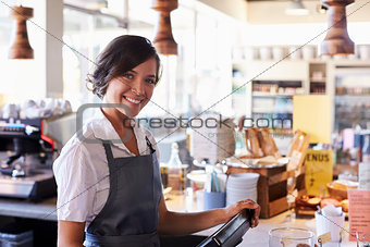 Portrait Of Female Employee Working At Delicatessen Checkout