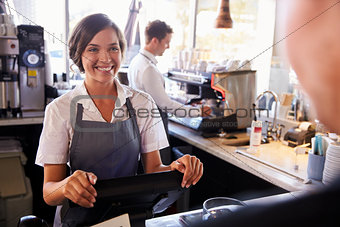 Woman Takes Customer Order In Coffee Shop