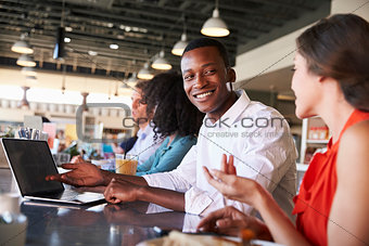 Business People Working At Counter In Coffee Shop